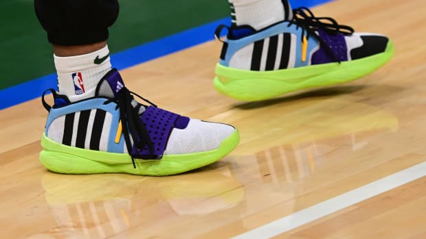 Milwaukee Bucks guard Damian Lillard's black and green adidas shoes.